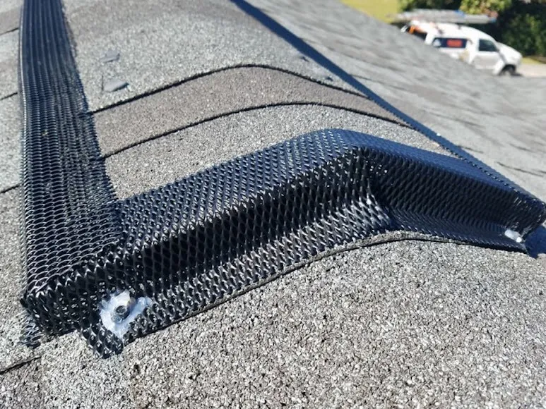 Ridge-vent exclusion. Steel mesh fitted along the roof line to close a run of open vent.